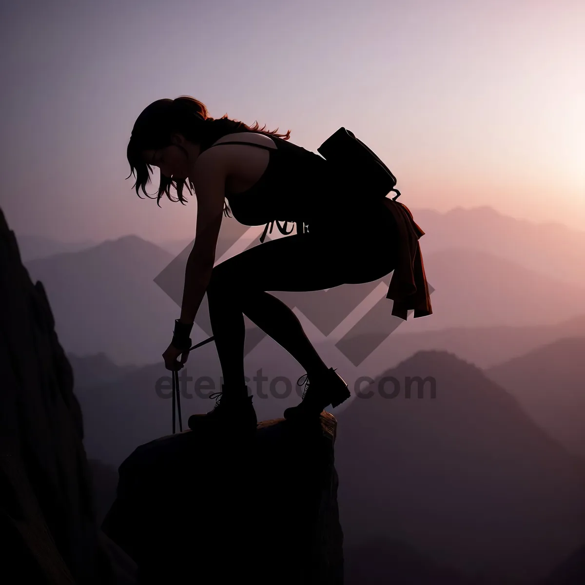 Picture of Mountain Cyclist Silhouetted Against Sunset Sky