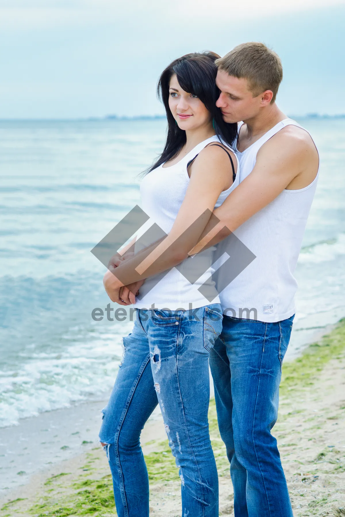 Picture of Happy young couple smiling on beach vacation.