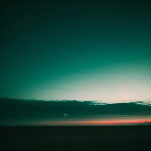 Vibrant Horizon: Sunlit Sky Over Coastal Plains