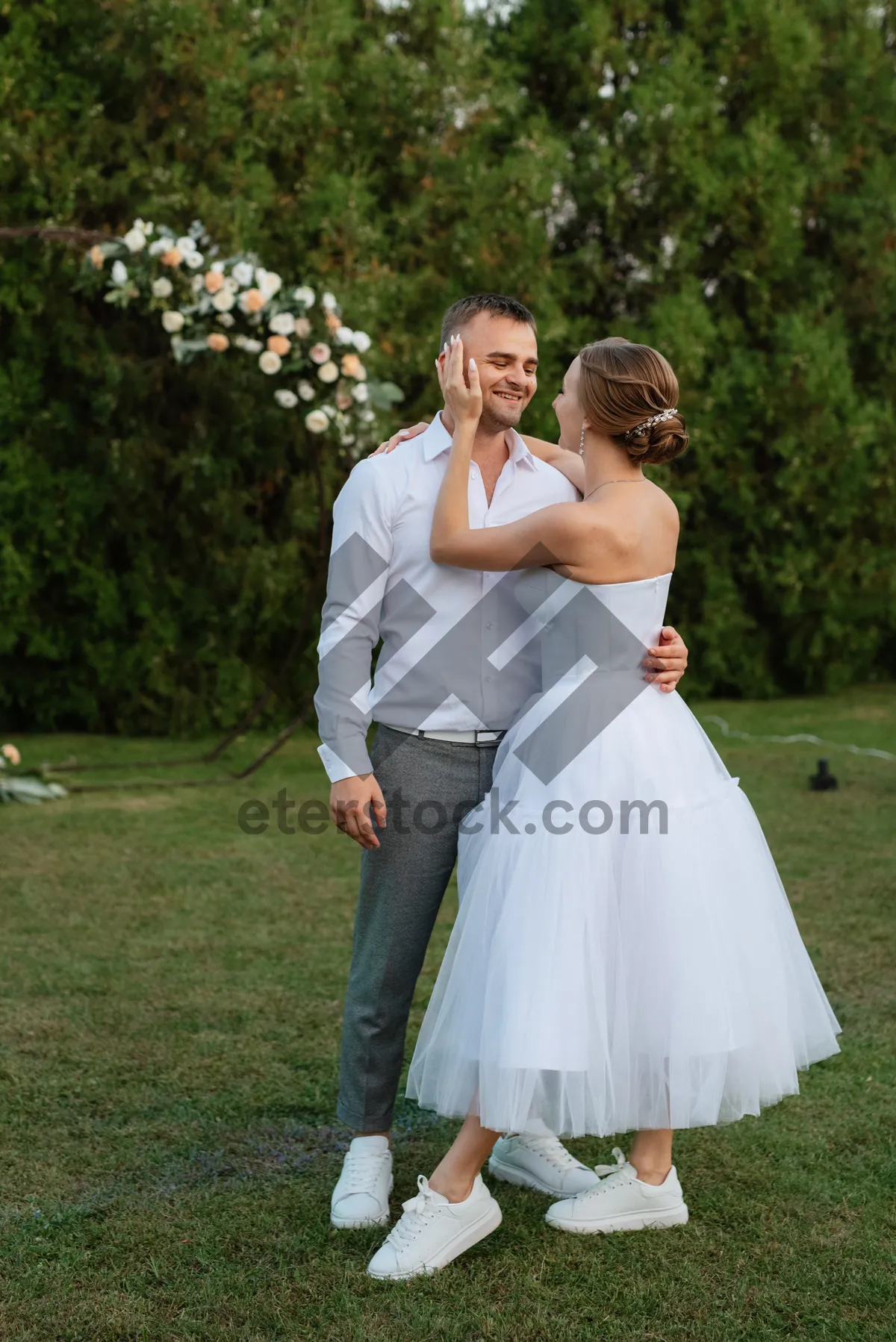 Picture of Happy newlyweds embrace on their wedding day.