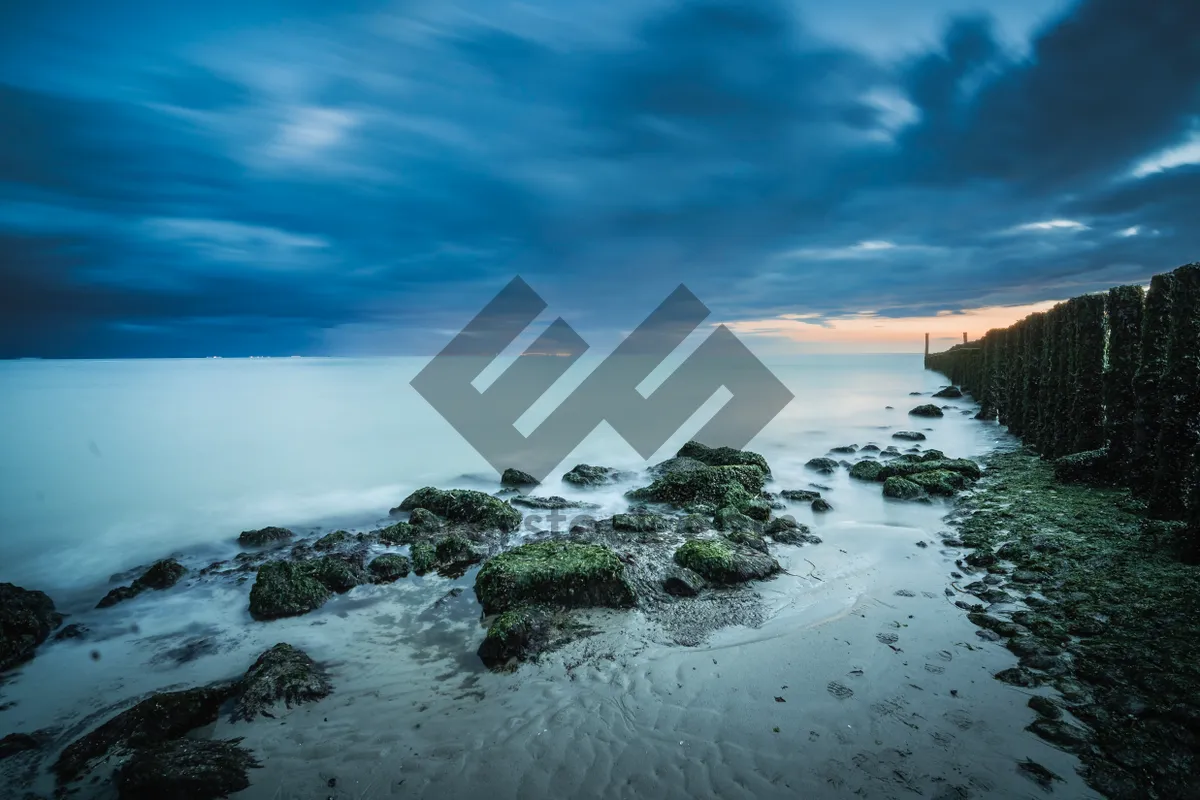 Picture of Tropical sunset beach landscape with waves and sun.