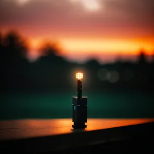 Sunset Beacon Tower Silhouetted in Orange Sky