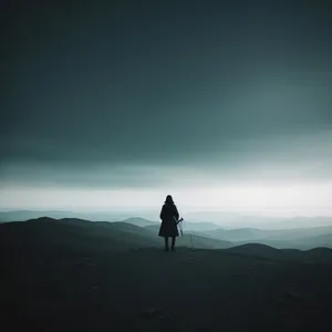 Silhouette Hiker Ascending Highland Mountain at Sunset.