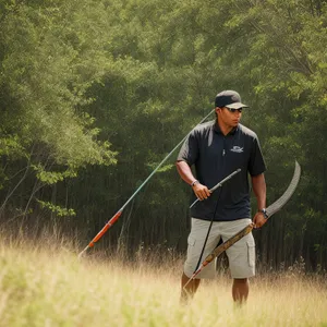 Active Farmer Sporting a Bow and Arrow Outdoors