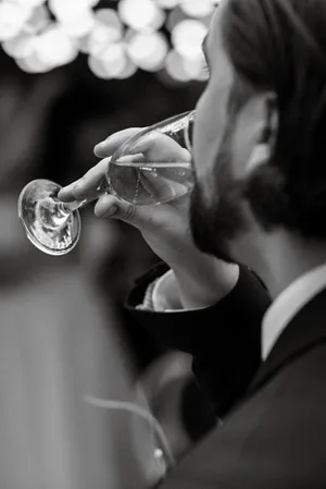 Sexy black male model with brass cornet and wine