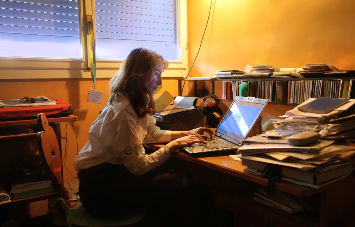 Picture of Happy professional team working in office with laptops