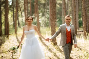 Happy bride and groom celebrating wedding day outdoors