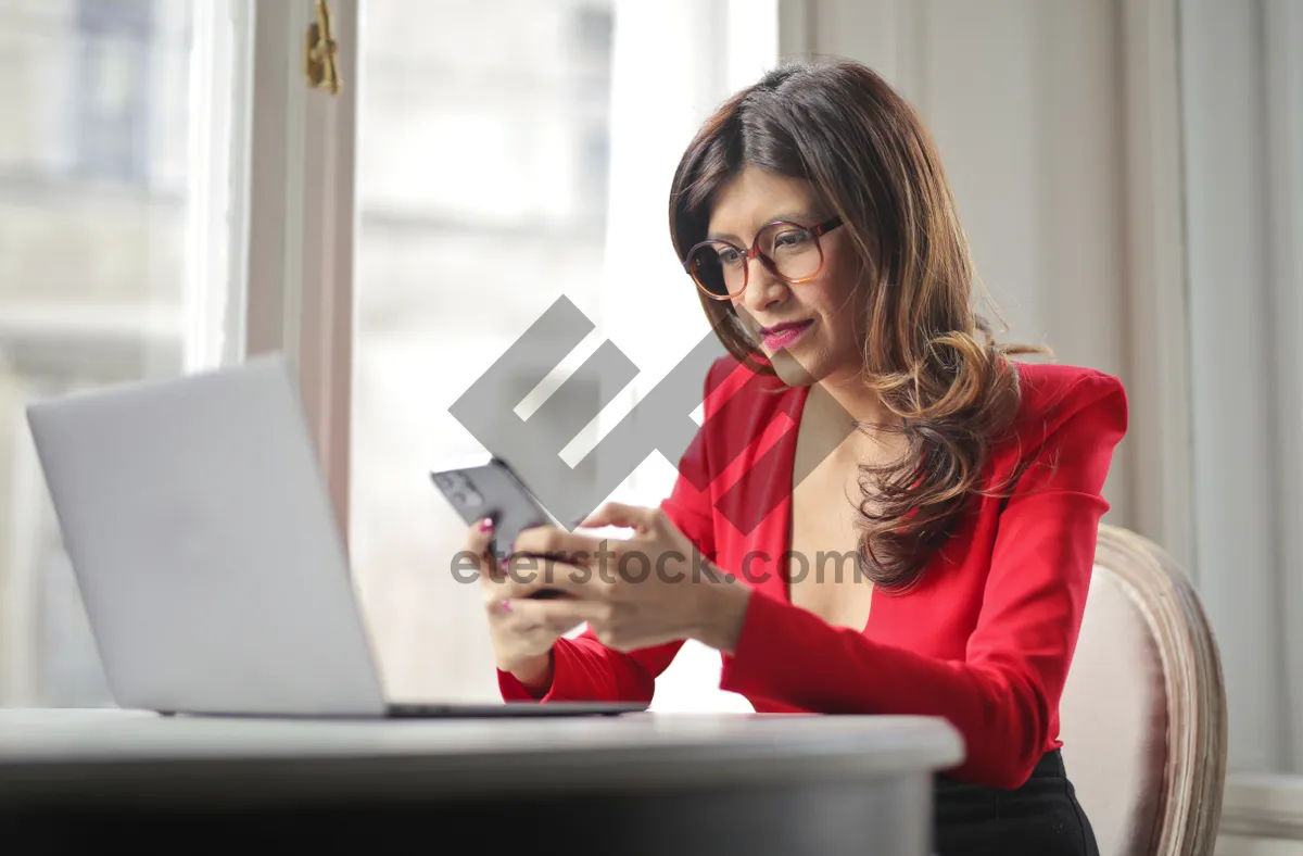 Picture of Happy professional businesswoman working on laptop at office desk