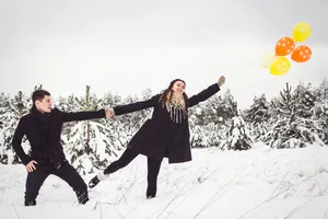 Happy man jumping on snowy mountain during winter ski