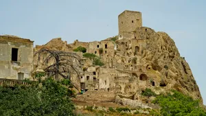 Medieval fortress against backdrop of blue sky.