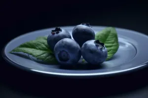 Fresh and Juicy Blueberries on Healthy Leafy Greens