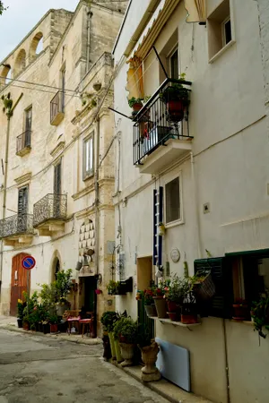 Old stone building with balcony in ancient city street.