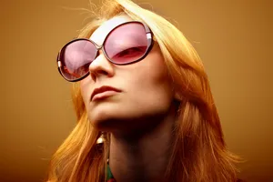 Stylish Blonde Model Smiling in Sunglasses Studio Portrait