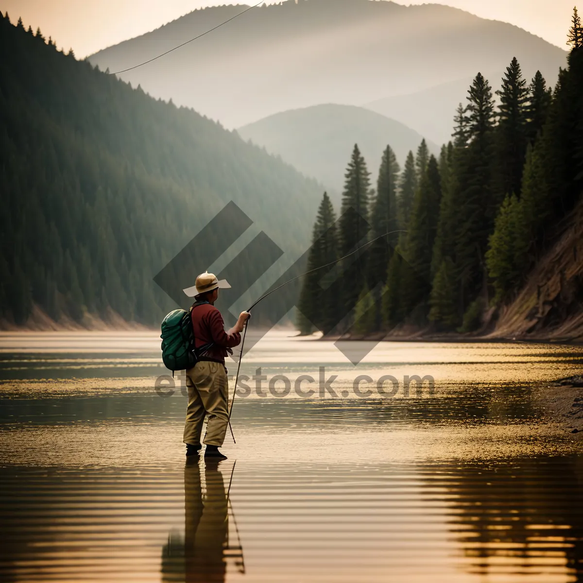 Picture of Man riding unicycle by river, surrounded by mountains.