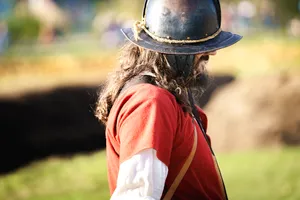 Person wearing protective hat and shield outdoors