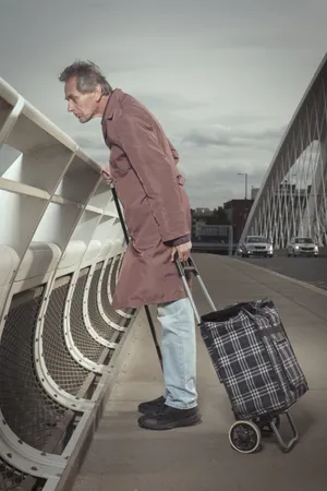 Adult businessman with crutch standing confidently