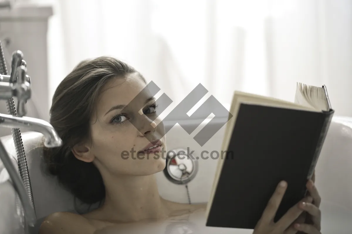 Picture of Smiling businesswoman working on laptop in office