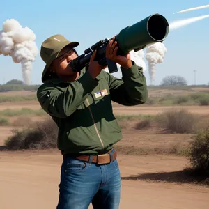 Man observing outdoors with binoculars on grassy field