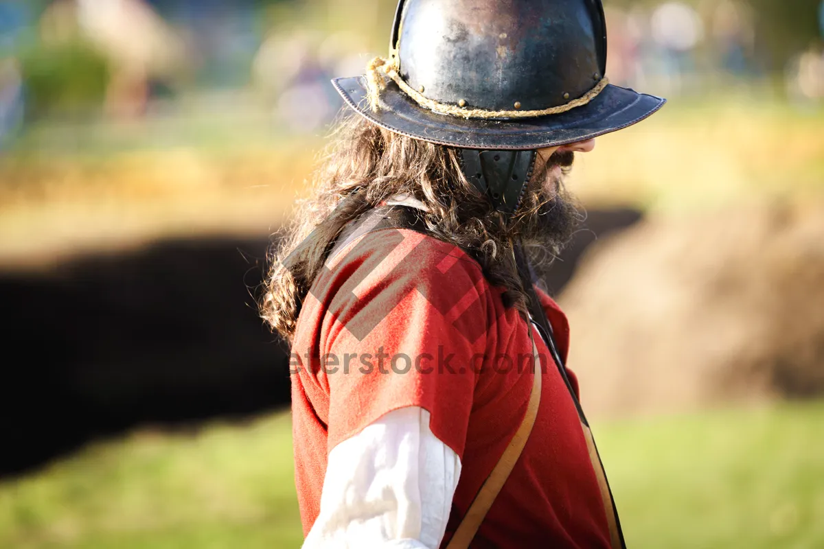 Picture of Person wearing protective hat and shield outdoors