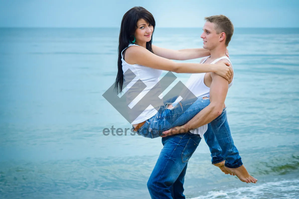 Picture of Happy couple running on beach at sunset