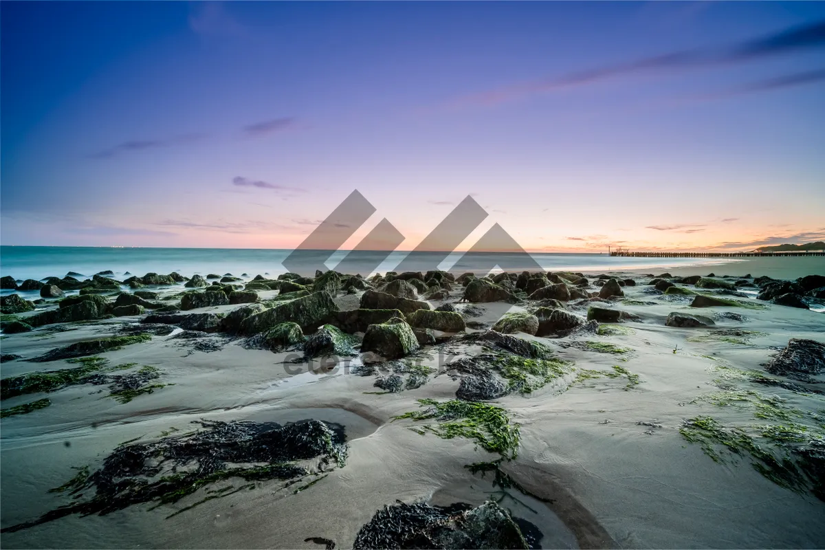 Picture of Tropical beach sunset over the ocean waves.
