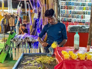 Fan seller at market stall