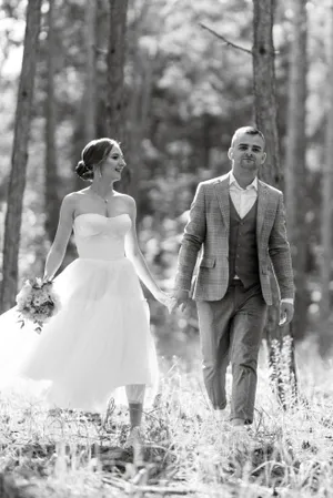 Happy couple celebrating wedding in the park.