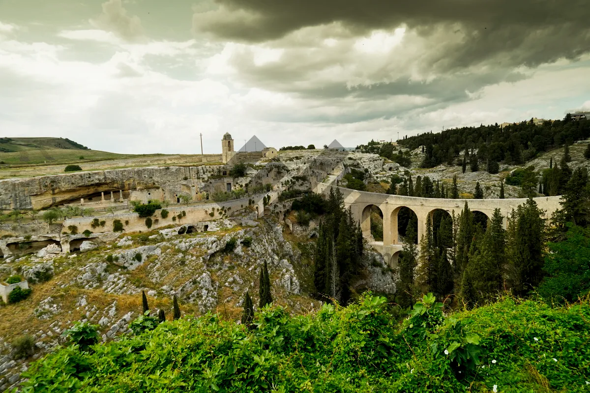 Picture of Ancient stone fortress against city skyline and river landscape