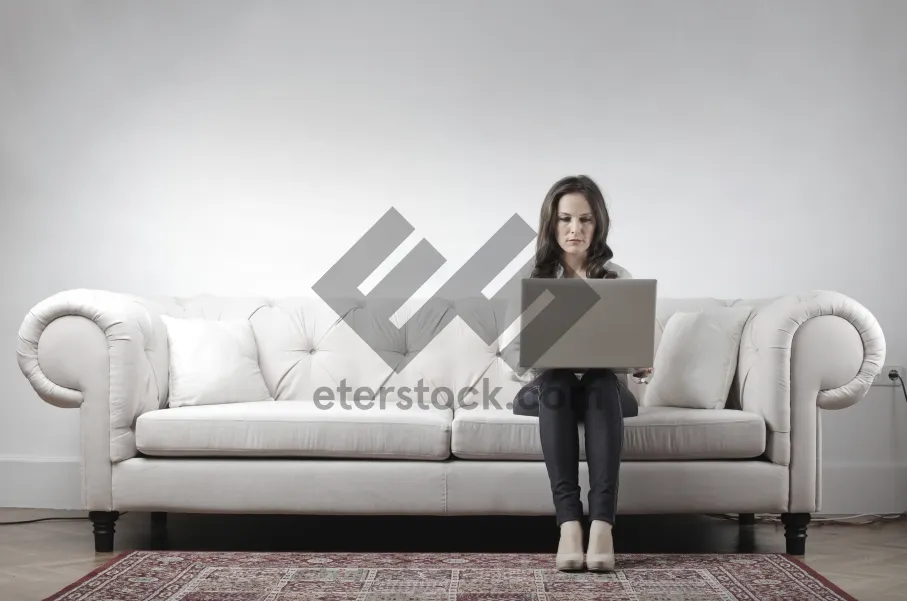 Picture of Happy adult sitting on modern leather sofa