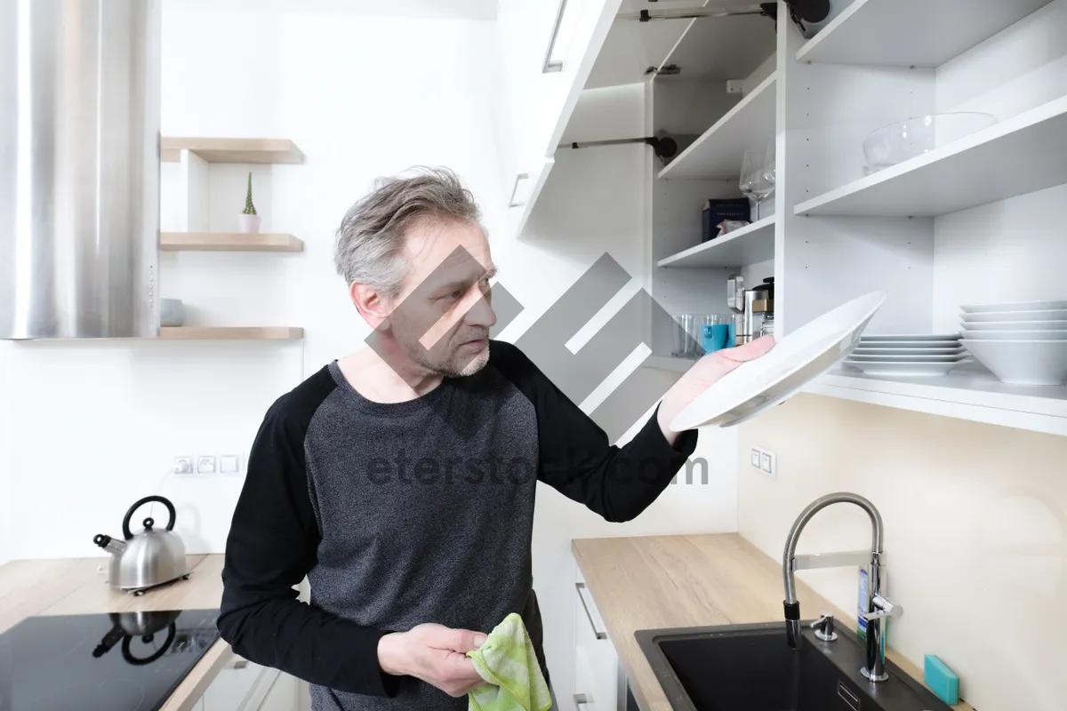 Picture of Happy male professional working on laptop at home office.