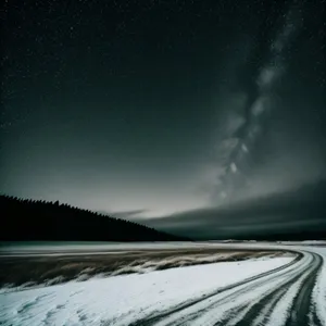 Majestic Night Sky Over Snowy Mountain Highway