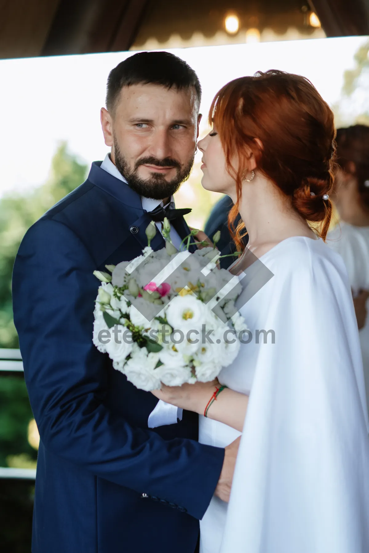 Picture of Happy newlywed couple outdoors smiling at their wedding