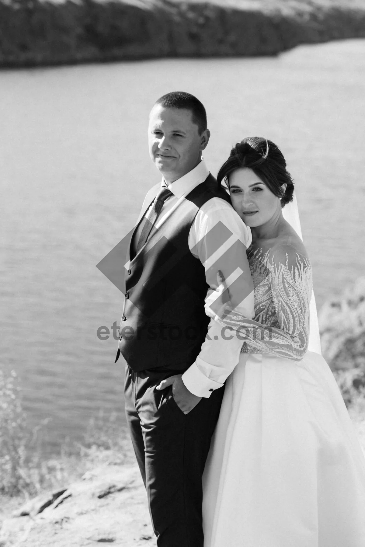 Picture of Happy married couple celebrating wedding outdoors with flowers.