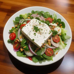 Gourmet grilled vegetable plate with fresh salad and cheese.