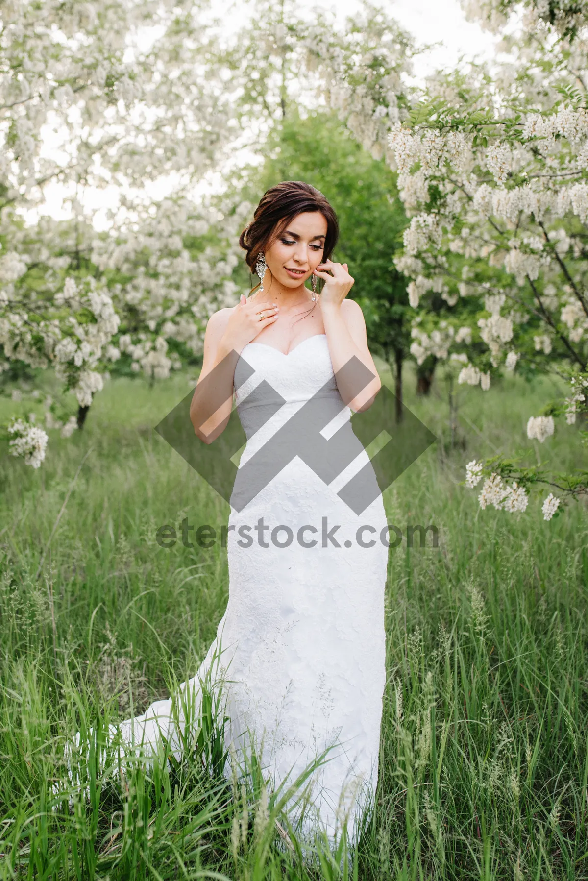 Picture of Attractive bride smiling in the park on her wedding day