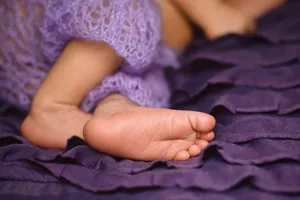 Baby hand receiving spa treatment from beautician