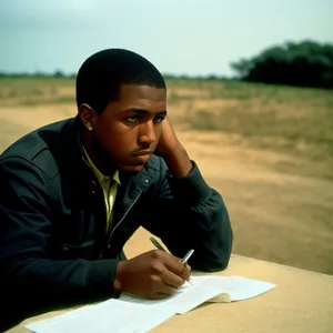 Happy businessman working on laptop outside.