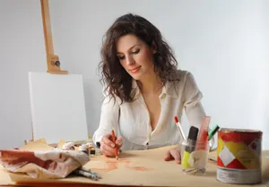 Smiling brunette businesswoman working on laptop at home office