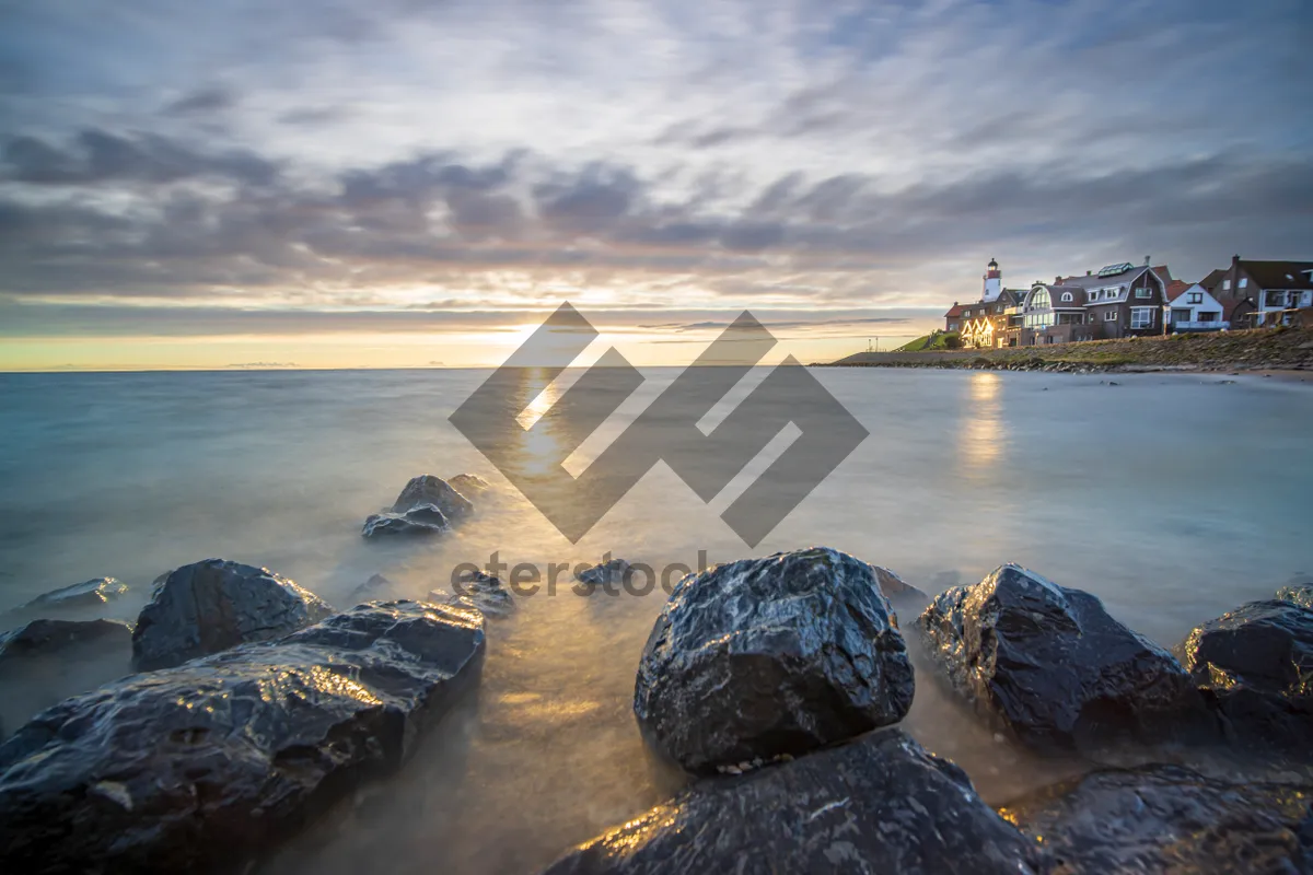 Picture of Sunset waves on rocky coastline nature travel background