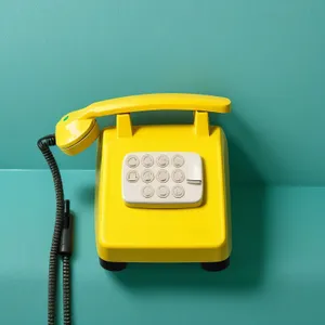 Vintage rotary dial telephone with cord connection.