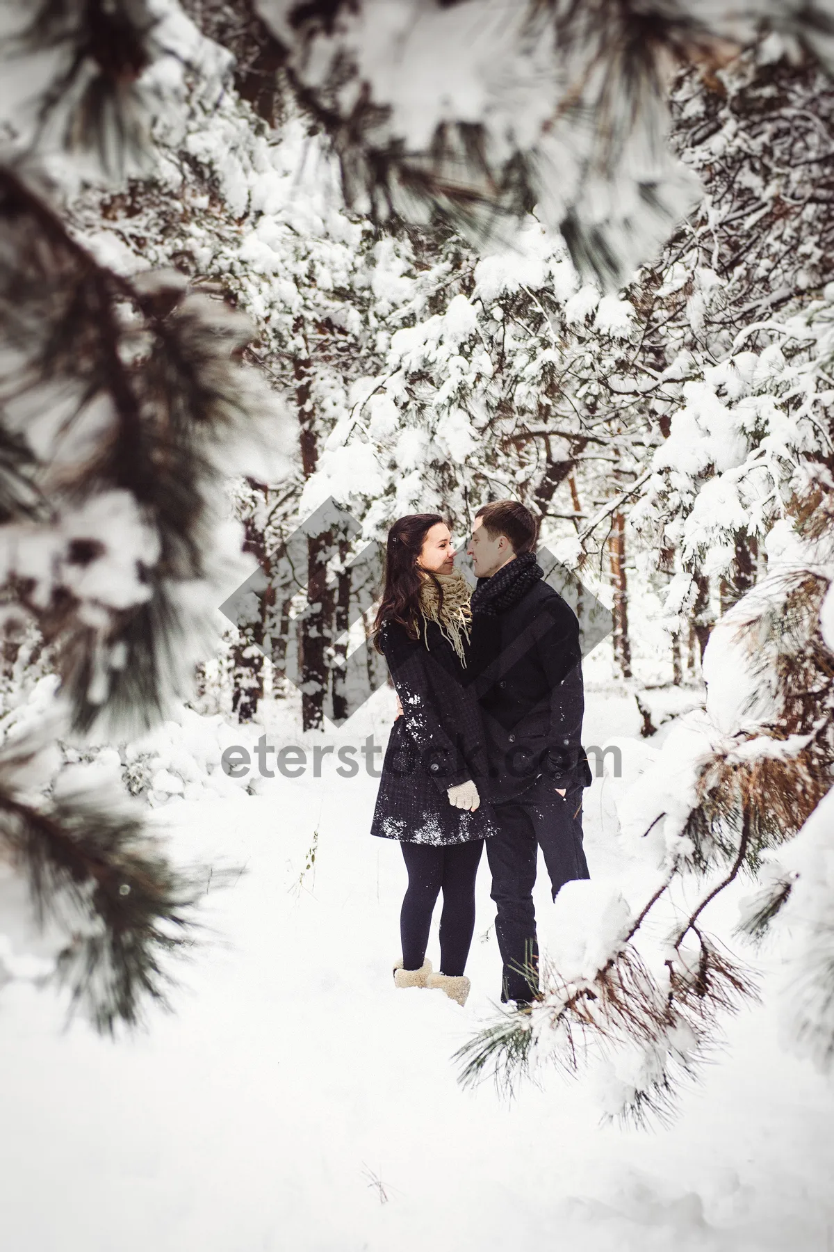 Picture of Man walking in snowy park with winter scenery.