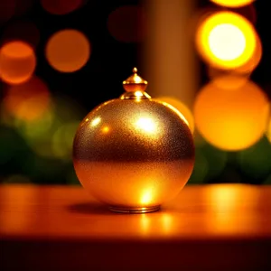 Glistening Gold Bauble Hanging from Festive Tree