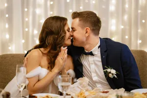 Happy bride and groom smiling together at wedding ceremony.