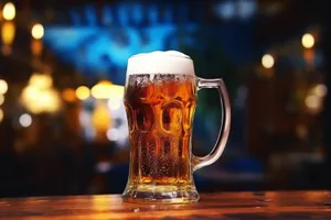 Yellow beer glass with bubbles at a pub