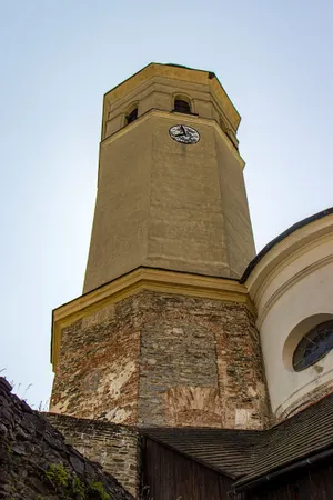 Old cathedral bell tower in city skyline.