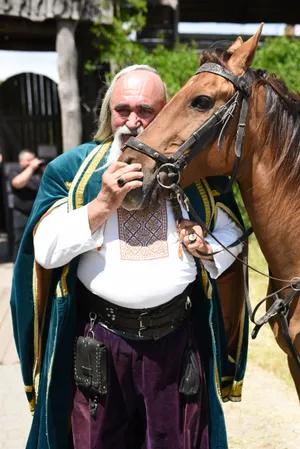 Musician playing flute with a horse listening attentively.