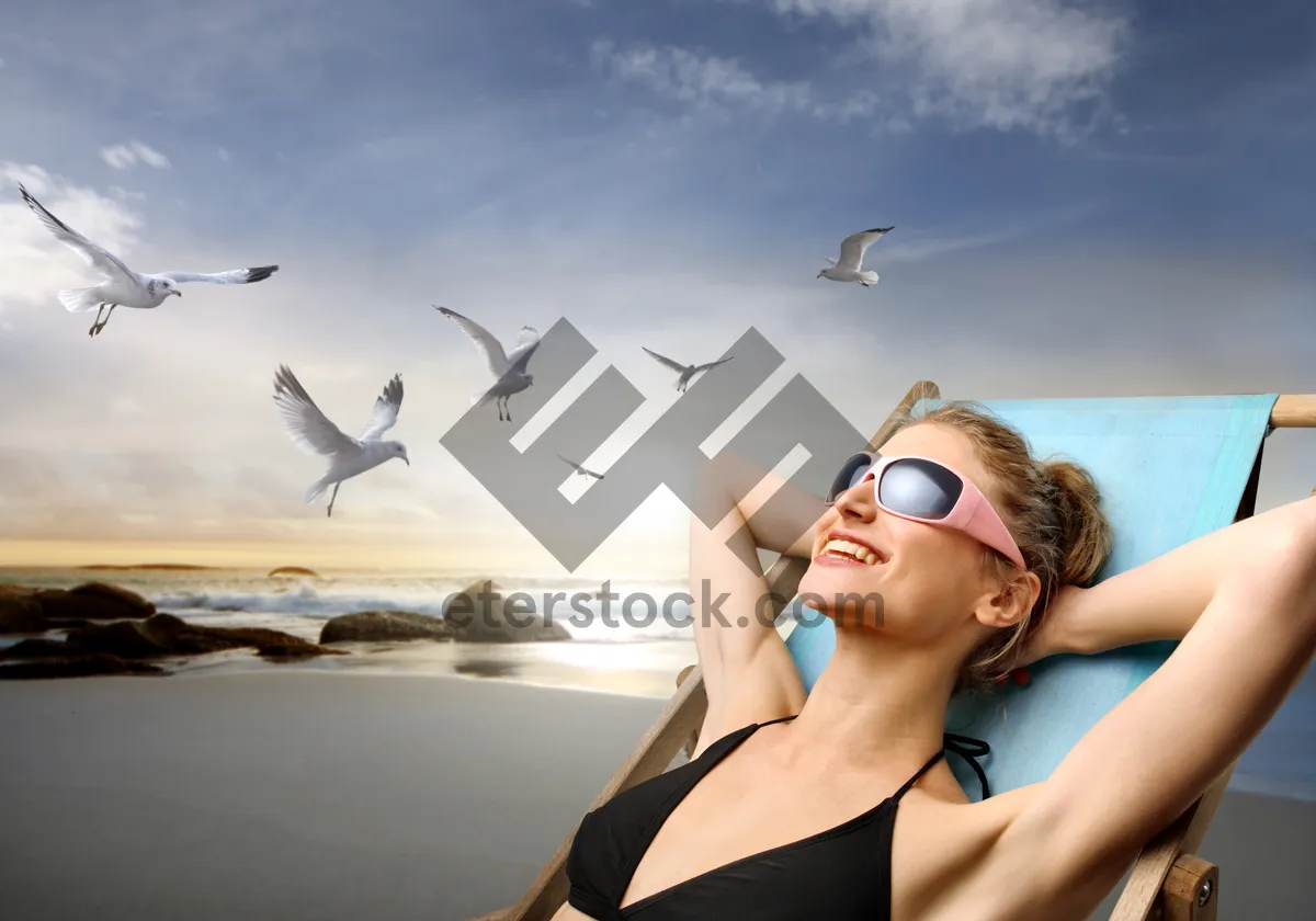 Picture of Smiling woman in bikini at tropical beach resort