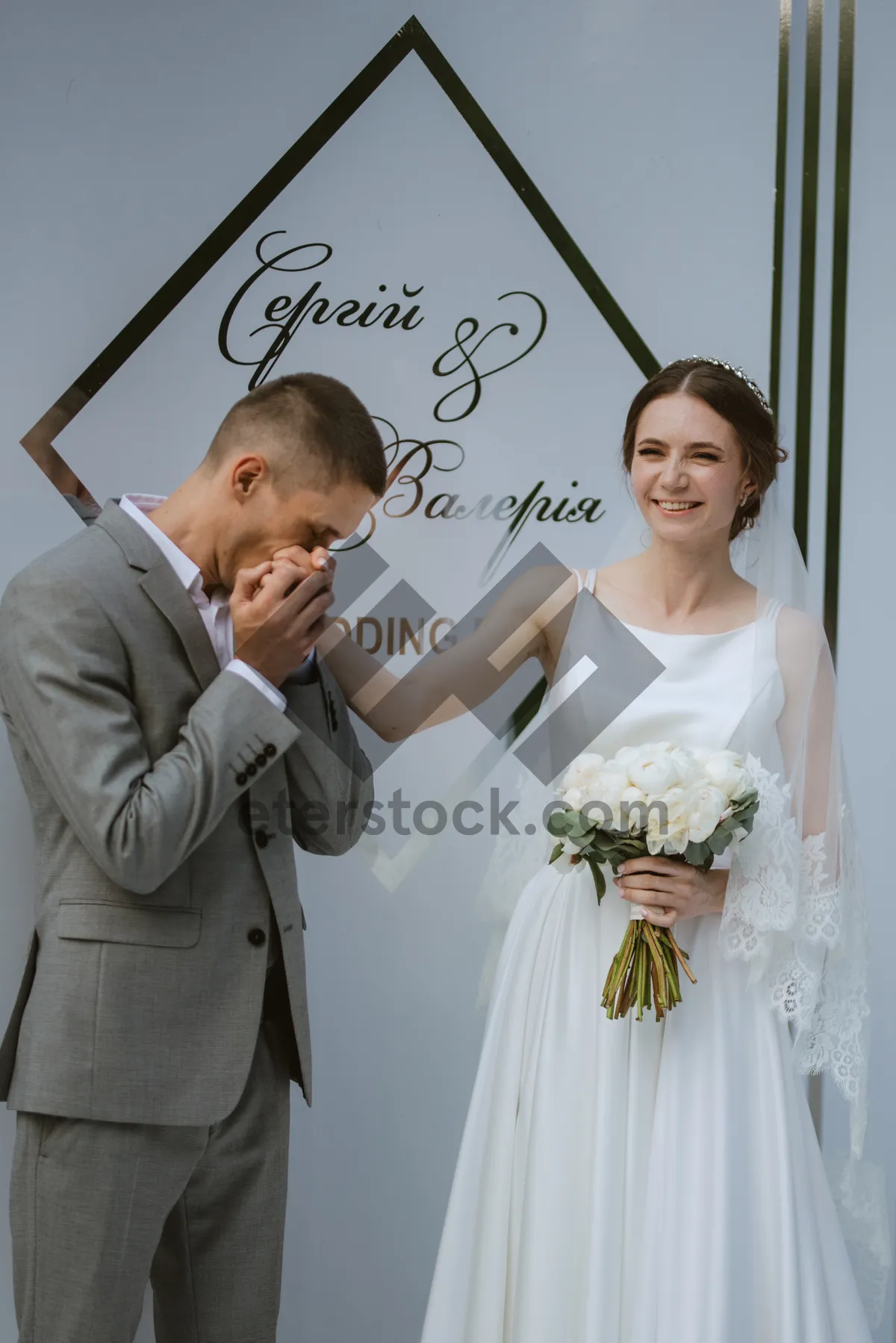 Picture of Happy wedding couple smiling with bouquet