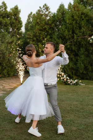 Happy groom and bride celebrating wedding day outdoors.