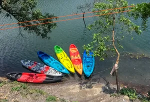 Tropical coastline with small boat and kayak.